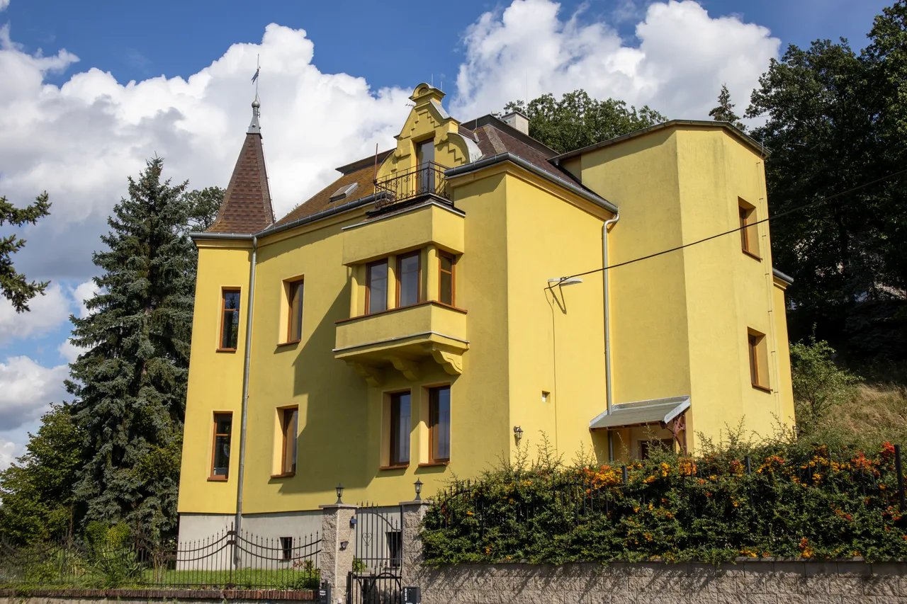 The yellow Art Nouveau Vila Matějka with its tower and garden