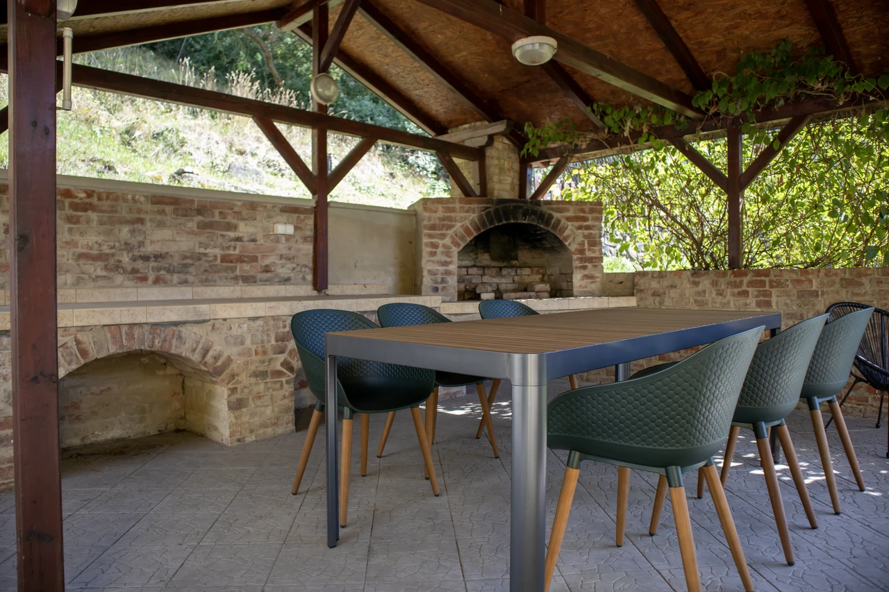 Covered garden gazebo with a table and barbecue at Vila Matějka